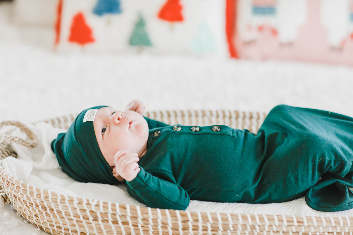 Baby in a knitted green outfit, closeup Stock Photo by ©tan4ikk 141572150